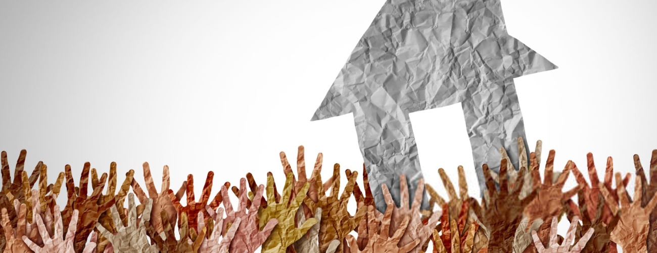 Selling A Home as a group of diverse home buyers reaching for real estate success in a seller market as a symbol for buying a house and affordability challenges to residential ownership.