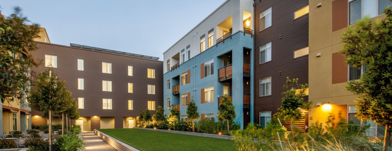 Modern apartment building at dusk.