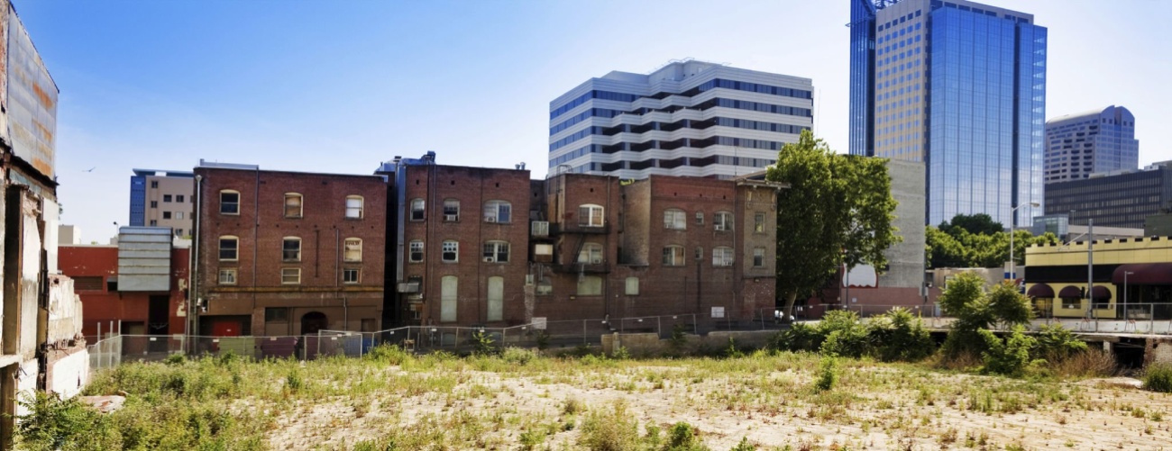 Turning Vacant Lots into Homes | Run down brick buildings and an empty lot in downtown Sacramento, California.