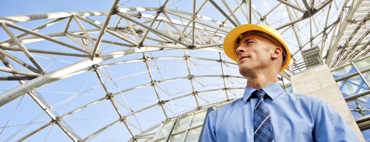 grok-image-ab52af73-db30-483b-82be-a63ed86fc5e0 Architect or Engineer in front of a modern urban structure.
