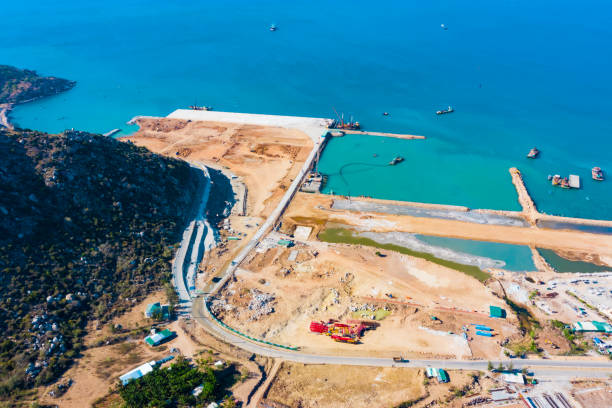 Construction for Marine works, Sea Port Being Built, Construction Steel Pipe Pile used Piling Barge for Driven Pile and Construction Site With Beautiful Nature And Coastal Background