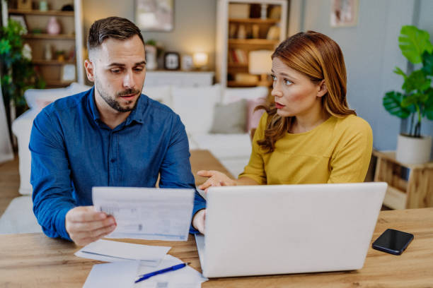 Young couple paying bills online