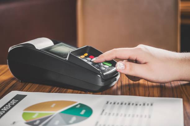 A customer using a credit card machine to pay for a purchase