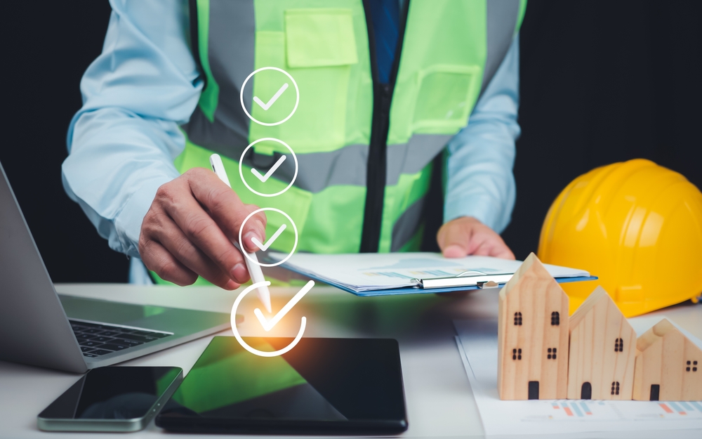 Validation of construction project inspection and approved building permits, with an architect or engineer reviewing documents and authorizing a residential building project.