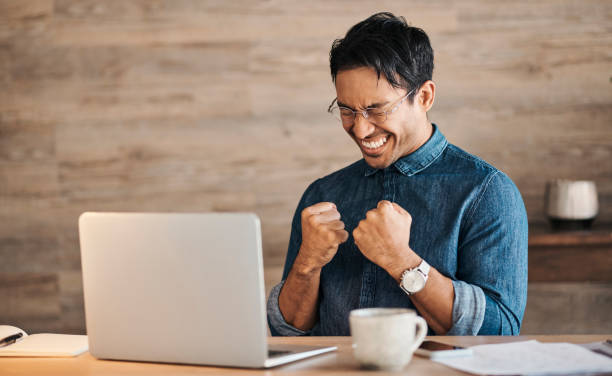 Success, winner and businessman on laptop with coffee celebrating winning, business deal or sales growth. Wow, entrepreneur or male from Canada in celebration of financial goals, mission or targets.