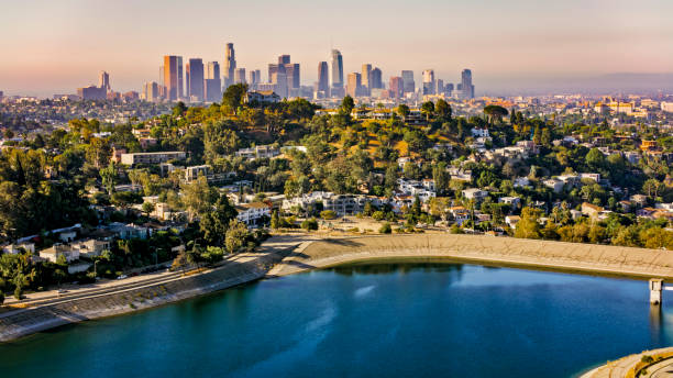 Aerial view of Silver Lake surrounded by neighbourhood with high rise office buildings in background, City Of Los Angeles, California, USA.