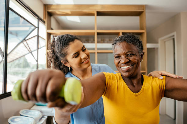 Elderly woman doing physical therapy with dumbbells in the article, Open Physical Therapy Clinic in M1 or CM Zone