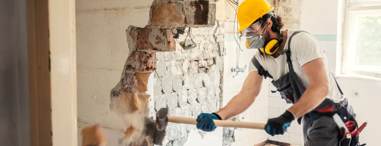 Worker using hammer, home renovation