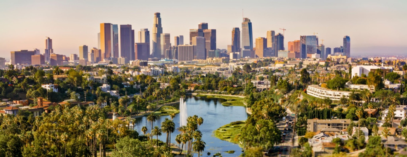 Aerial view of Echo Park Lake surrounded by neighbourhood with high rise office buildings in background, City Of Los Angeles, California, USA.