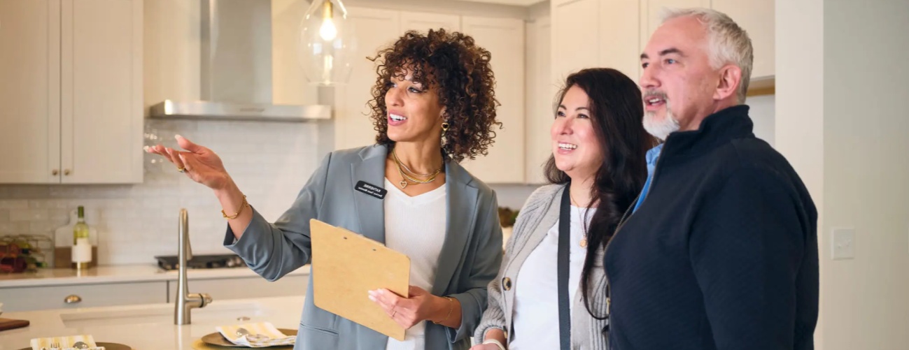 A professional real estate agent, showing a new home to prospective buyers.