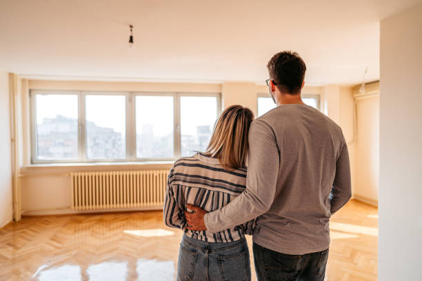 Young loving heterosexual couple embracing in their new home.