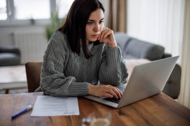 Determined woman reviewing job opportunities online