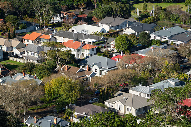 Aerial view of a well-planned suburban community featuring rows of houses, green spaces and connecting roads.