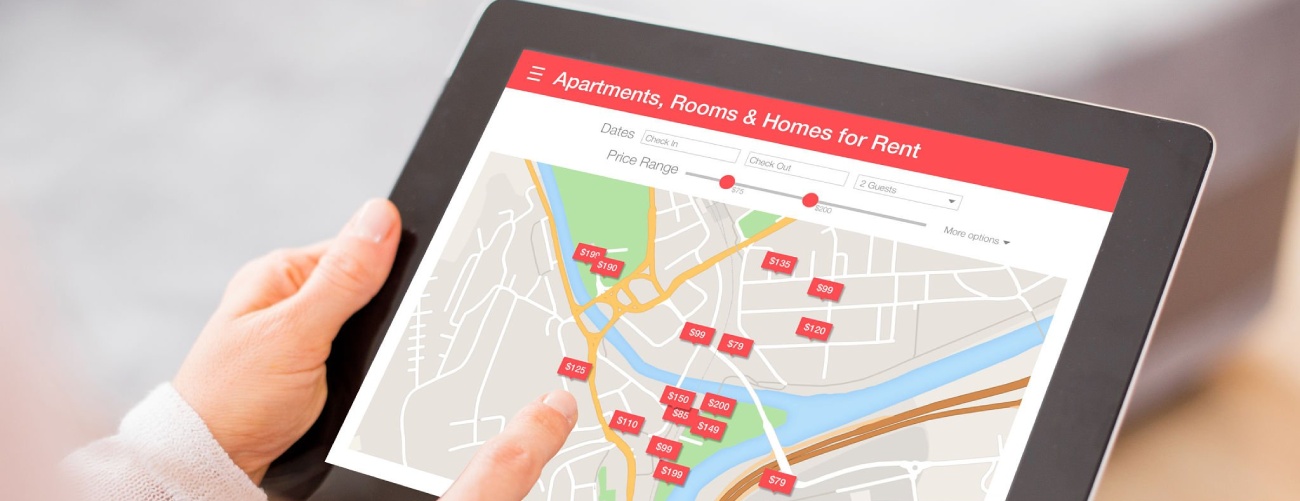 Person looking for places to stay on digital tablet app