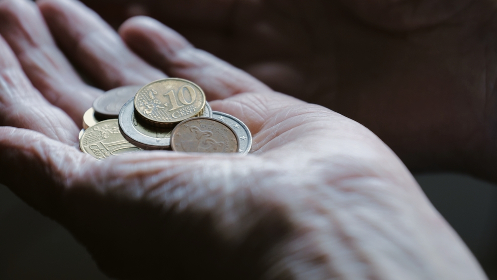 Hands with small change close-up. The concept of poverty. Women's hands with change, euro. Lack of livelihood. Coins in an open palm