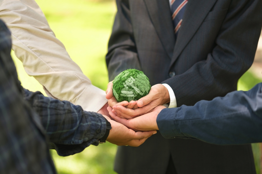 Businessmen join together to hold up a globe with the gavel logo. Concept. Global environmental law and global industry.