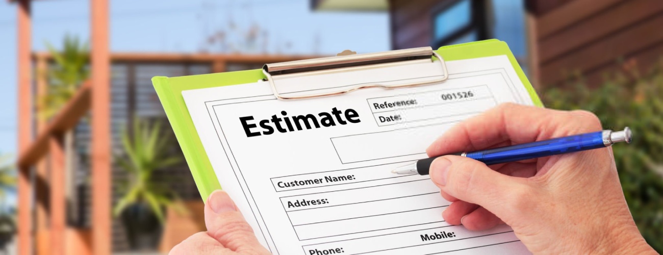 Hand writing an estimate on a clipboard for Home Building Renovation
