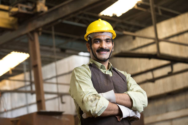 Confident industrial worker in protective workwear at factory