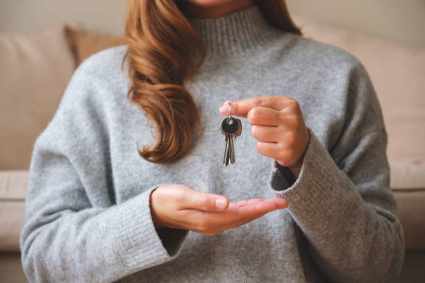 Closeup image of a woman holding the keys for real estate concept