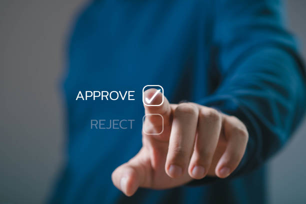 Close-up of a person touching a virtual button to approve a choice, showcasing modern digital decision-making in a business environment.