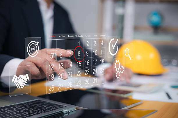 Architect or engineer pointing finger at construction marking dates on virtual calendar, Project presentation plan, Construction planning, Appointment scheduler, Set reminders for important project.