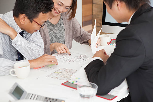 Couple meeting architect for house construction