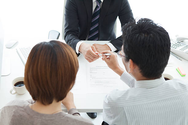 Man and woman signing loan contract