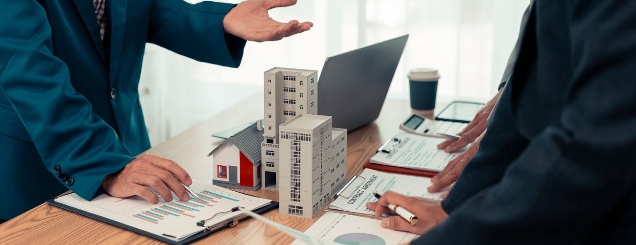 Real estate developers, architects and business teams working on a new business building project in a conference office highlight investment strategies and real estate decisions for future plans.