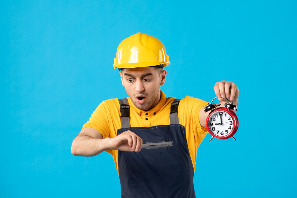 Front view of male worker in uniform with clocks being late on the blue