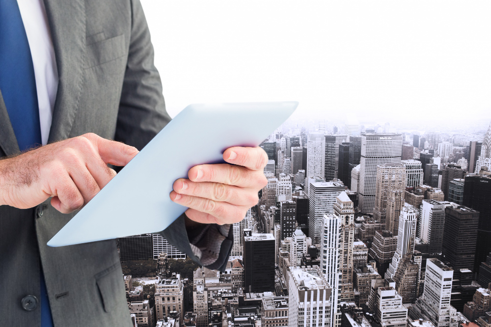 Executive with tablet and buildings background