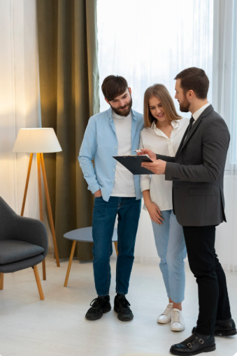 Male real estate agent doing business and showing house to potential buying couple 