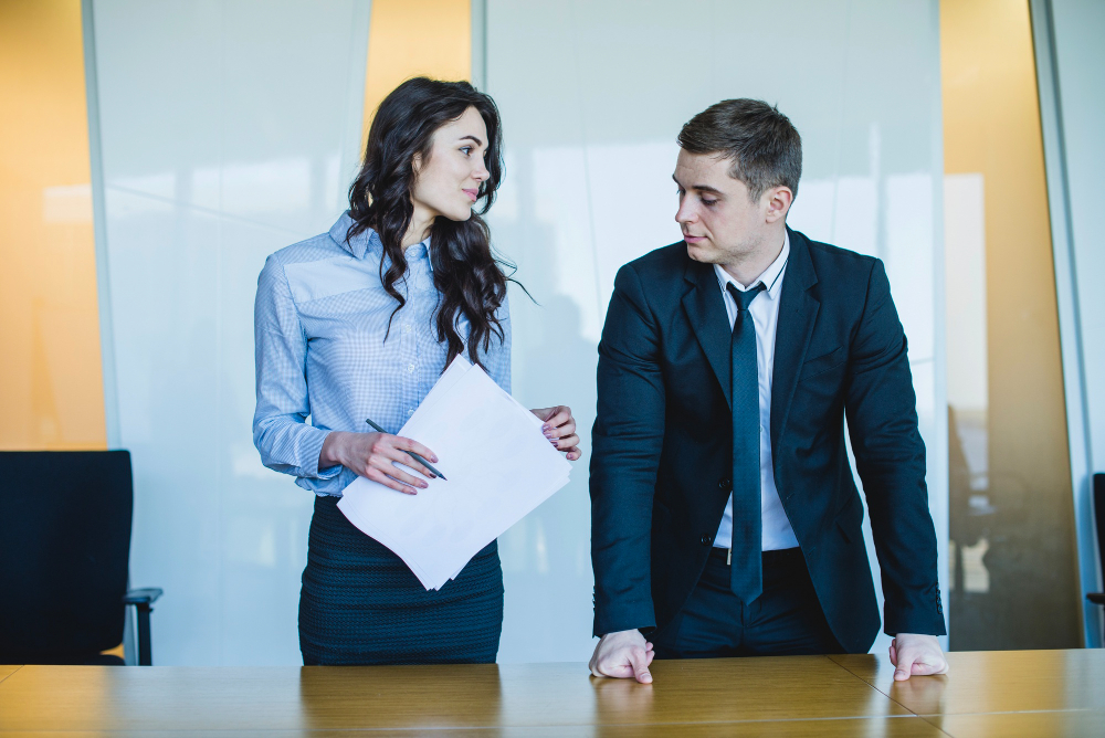 Managers standing in front of desk