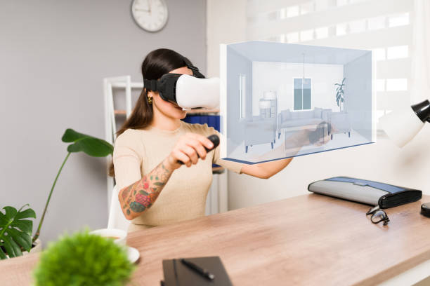 Virtual house tour. Young woman using a VR headset and joystick while making a real estate immersive tour