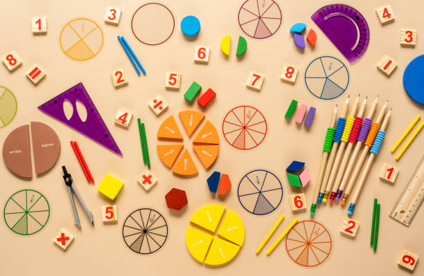 Wooden toy blocks. School supplies, math fractions, pencils, numbers, on beige background. Back to school, education concept background