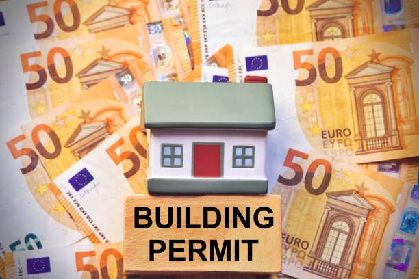 Small house on the background of Euro banknotes and the text Building Permit.