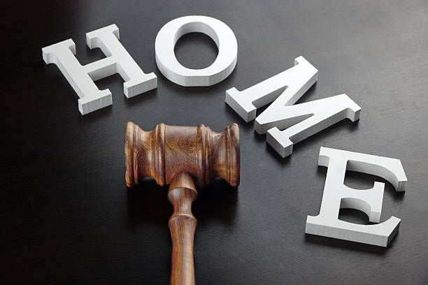 Judges Or Auctioneer Gavel And White Sign Home Made From Wooden Letter On Black Wood Table Background In Back Light, Close Up, Conceptual Image.