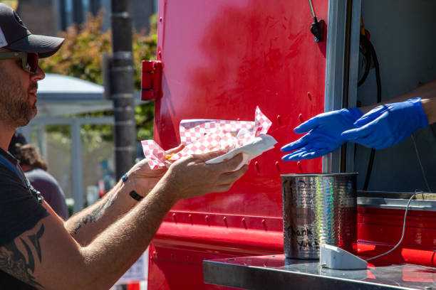 Everett, WA - USA 08-28-2021: Downtown Food Truck Festival - Man Receives His Order