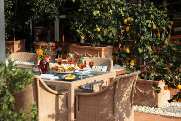 Garden Party Outdoor table with food and drinks appetizer antipasti plate for hosting guests on mediterranean terrace patio