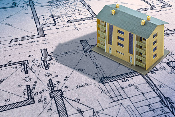 OLD CONDOMINIUM BUILDING FROM THE SEVENTIES WITH ARCHITECTURAL DRAWING RELIEF of the planimetry of an old building and condominium residential building model - Concept with copy space