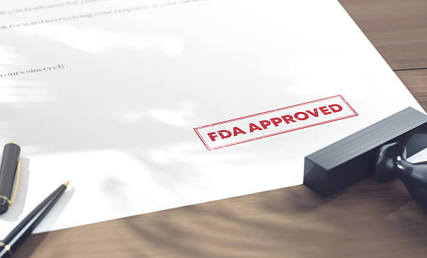 The Stamp Of FDA Approved On Official Documents. Legal System Concept.