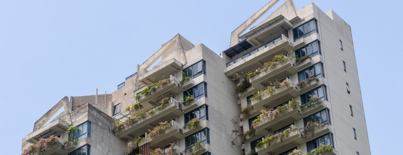 grok-image-ab52af73-db30-483b-82be-a63ed86fc5e0 High rise residential building located at Forest City, Malaysia. Originally struggling as a ghost town, it is currently being revived as a Special Financial Zone