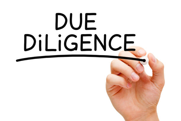 Hand writing Due Diligence with black marker. Research done before entering into a contract or agreement as a part of the risk management process.