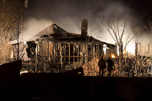 "Firefighters watch the last few flames destroy an Arvada, Colorado home and barn. Fires stretched for more than five miles along train tracks and were caused by a westbound train, investigators stated February 25, 2009. According to the Arvada Fire Department, numerous witnesses saw sparks from the train ignite the dry grasses next to the train tracks."