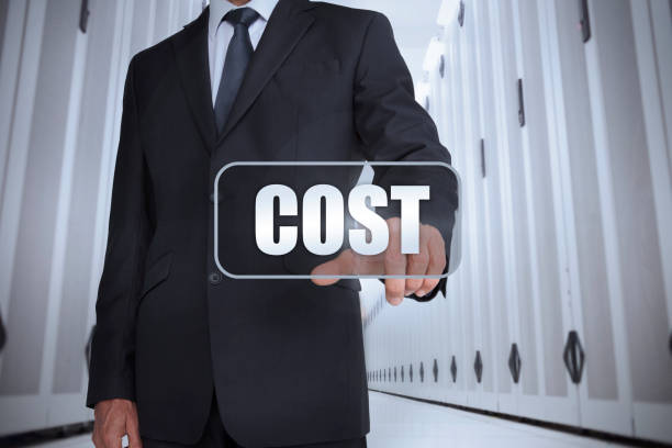 Businessman in a data center selecting label with cost written on it