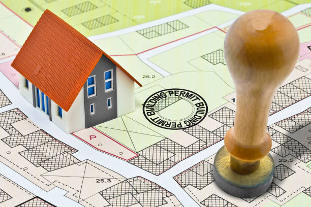 Buildings Permit concept with imaginary General Urban Plan and cadastral map home model and wooden stamp